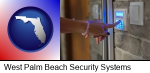 West Palm Beach, Florida - woman pressing a key on a home alarm keypad