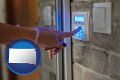 south-dakota map icon and woman pressing a key on a home alarm keypad
