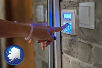 woman pressing a key on a home alarm keypad - with Alaska icon