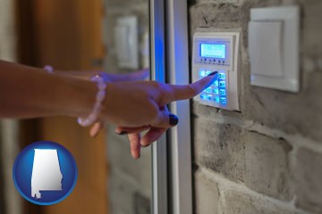 woman pressing a key on a home alarm keypad - with Alabama icon