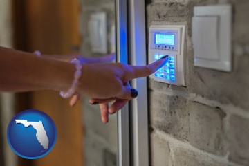 woman pressing a key on a home alarm keypad - with Florida icon