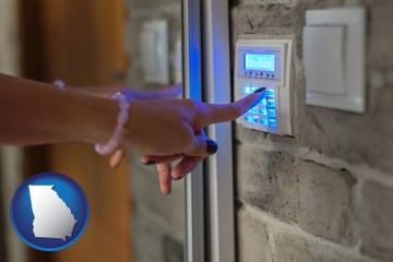 woman pressing a key on a home alarm keypad - with Georgia icon