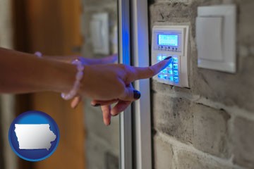 woman pressing a key on a home alarm keypad - with Iowa icon