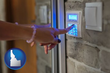 woman pressing a key on a home alarm keypad - with Idaho icon