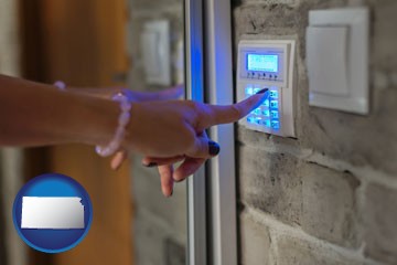 woman pressing a key on a home alarm keypad - with Kansas icon