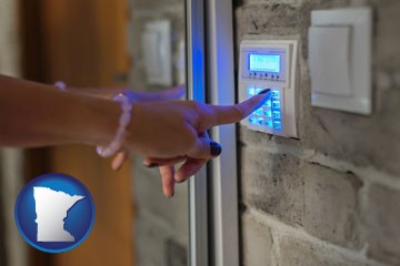 woman pressing a key on a home alarm keypad - with Minnesota icon