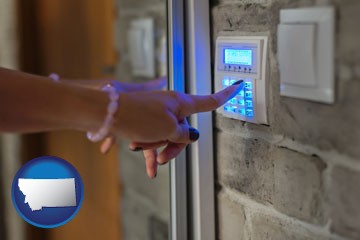 woman pressing a key on a home alarm keypad - with Montana icon