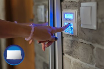 woman pressing a key on a home alarm keypad - with North Dakota icon