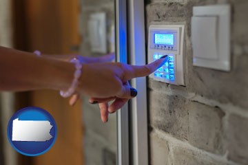 woman pressing a key on a home alarm keypad - with Pennsylvania icon