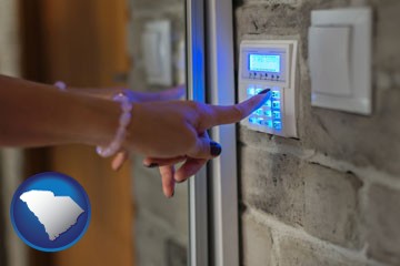 woman pressing a key on a home alarm keypad - with South Carolina icon