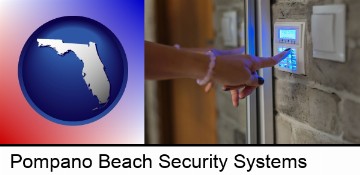 woman pressing a key on a home alarm keypad in Pompano Beach, FL