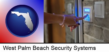 woman pressing a key on a home alarm keypad in West Palm Beach, FL